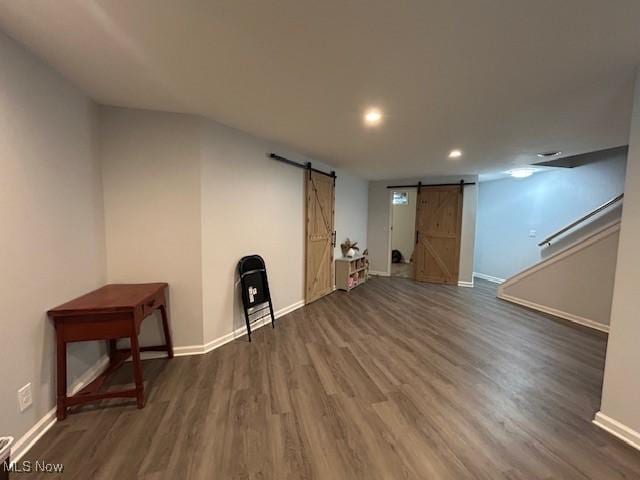 4718 Brushwood Rd, Wakeman, OH 44889 - below grade area featuring a barn door, baseboards, wood finished floors, and recessed lighting
