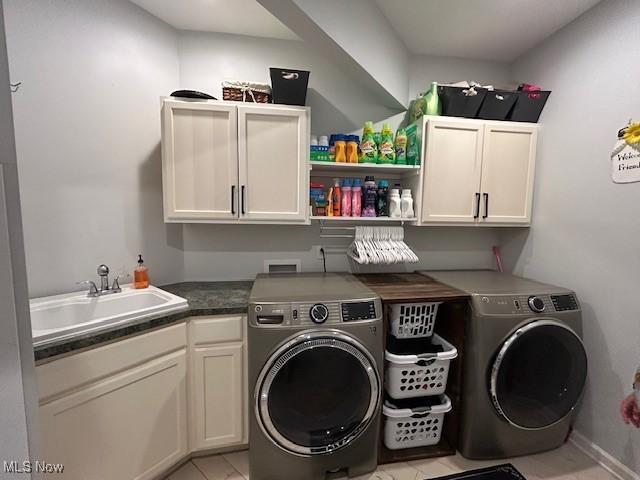 4718 Brushwood Rd, Wakeman, OH 44889 - clothes washing area with washing machine and clothes dryer, cabinet space, and light tile patterned floors