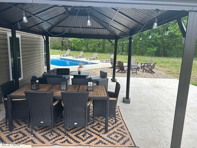 4718 Brushwood Rd, Wakeman, OH 44889 - view of patio featuring a gazebo, an outdoor pool, an outdoor fire pit, and outdoor dining area