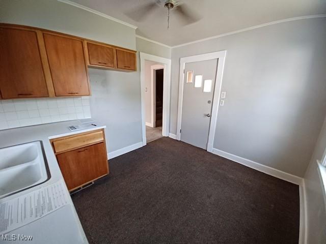 438 Elberen St, Youngstown, OH 44509 - kitchen featuring brown cabinets, ceiling fan, light countertops, ornamental molding, and backsplash
