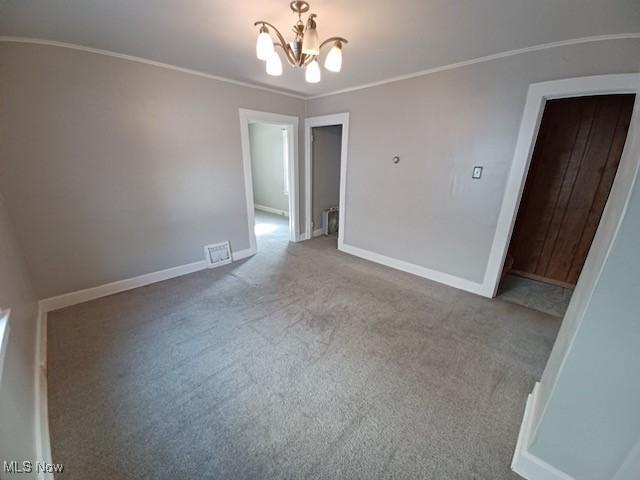 438 Elberen St, Youngstown, OH 44509 - carpeted empty room featuring a chandelier, baseboards, and ornamental molding
