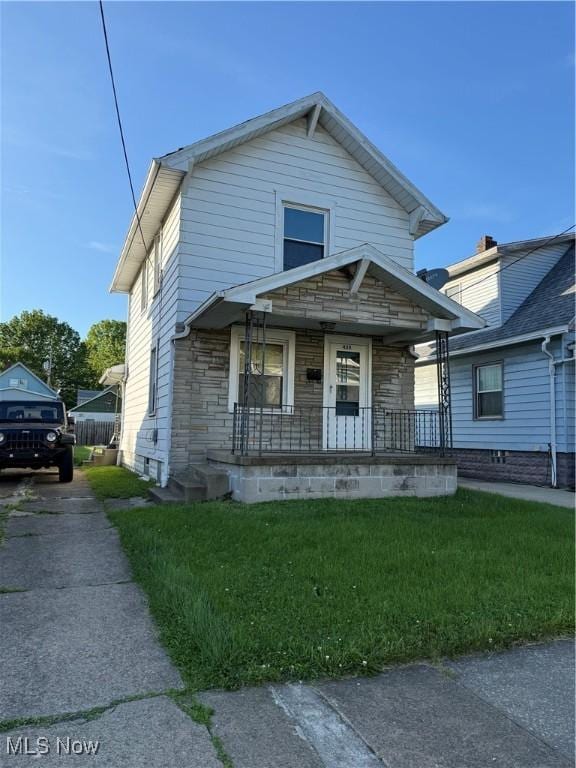 438 Elberen St, Youngstown, OH 44509 - view of front of house with a porch, stone siding, and a front yard