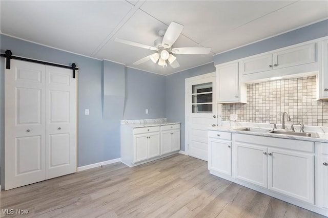 215 Holford Ave, Niles, OH 44446 - kitchen with a sink, ceiling fan, white cabinets, tasteful backsplash, and light countertops