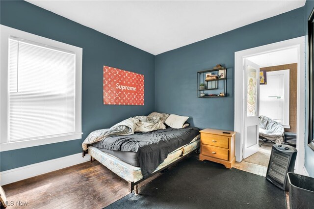 3436 Beechwood Ave, Cleveland Heights, OH 44118 - bedroom with baseboards, wood finished floors, and multiple windows