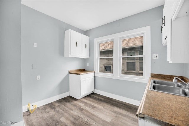 3436 Beechwood Ave, Cleveland Heights, OH 44118 - kitchen with a sink, white cabinetry, dark wood-style flooring, and baseboards