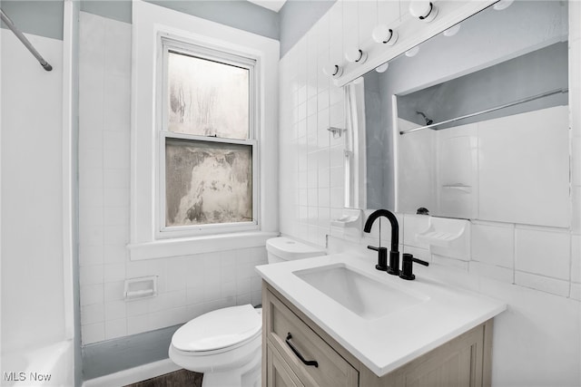 3436 Beechwood Ave, Cleveland Heights, OH 44118 - bathroom with tile walls, toilet, vanity, a shower, and tasteful backsplash
