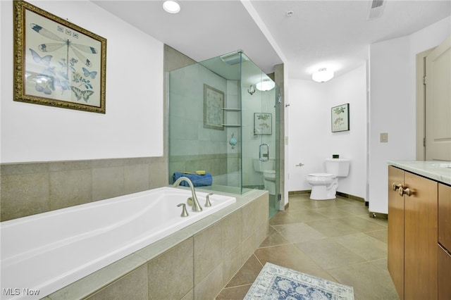 1466 S Main St Unit 103, North Canton, OH 44720 - bathroom featuring toilet, a stall shower, a garden tub, tile patterned flooring, and vanity