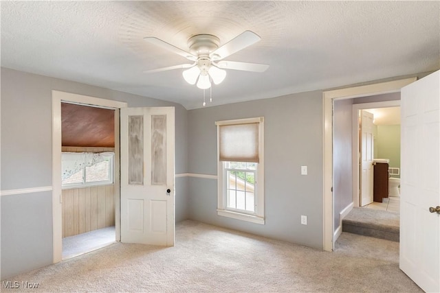315 W Main St, Canfield, OH 44406 - unfurnished bedroom featuring carpet, multiple windows, a textured ceiling, and a ceiling fan