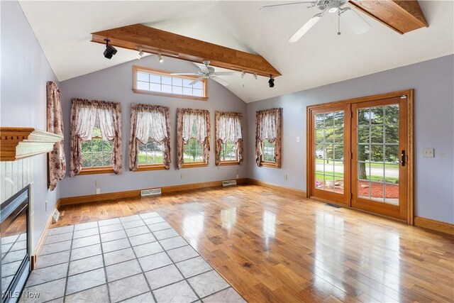 315 W Main St, Canfield, OH 44406 - unfurnished living room featuring a ceiling fan, light wood-style floors, a tile fireplace, rail lighting, and baseboards