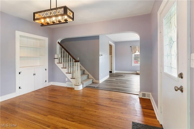 315 W Main St, Canfield, OH 44406 - entrance foyer featuring arched walkways, wood finished floors, stairway, and baseboards