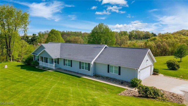 99 Township Road 262, Bloomingdale, OH 43910 - single story home with a front yard, concrete driveway, an attached garage, and covered porch