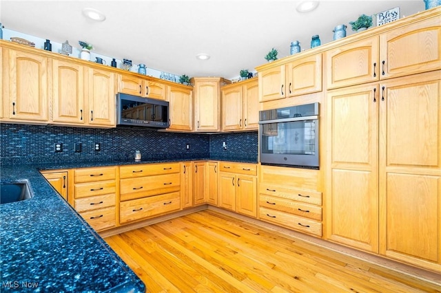 99 Township Road 262, Bloomingdale, OH 43910 - kitchen featuring stainless steel oven, light brown cabinets, light wood-style floors, tasteful backsplash, and recessed lighting