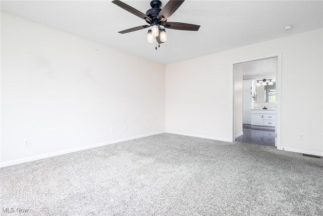 99 Township Road 262, Bloomingdale, OH 43910 - unfurnished bedroom featuring baseboards, dark carpet, ensuite bath, and ceiling fan
