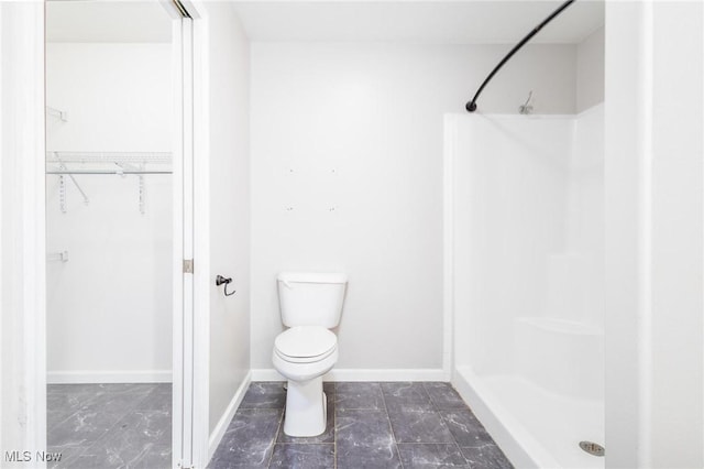 99 Township Road 262, Bloomingdale, OH 43910 - full bathroom featuring a stall shower, a walk in closet, toilet, baseboards, and marble look tile flooring