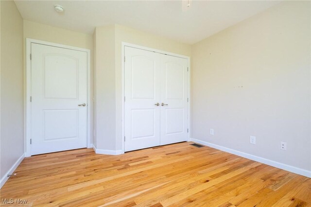 99 Township Road 262, Bloomingdale, OH 43910 - unfurnished bedroom with baseboards, light wood-style flooring, and a closet