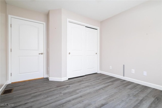 99 Township Road 262, Bloomingdale, OH 43910 - unfurnished bedroom featuring wood finished floors, baseboards, and a closet