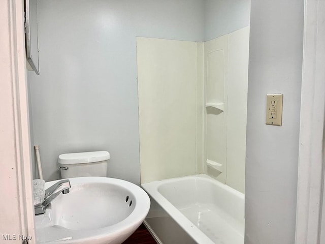 1104 4th St SW, Massillon, OH 44647 - bathroom with a sink, toilet, and shower / washtub combination