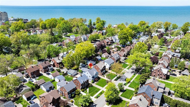 aerial view of property's location with nearby suburban area and a nearby body of water