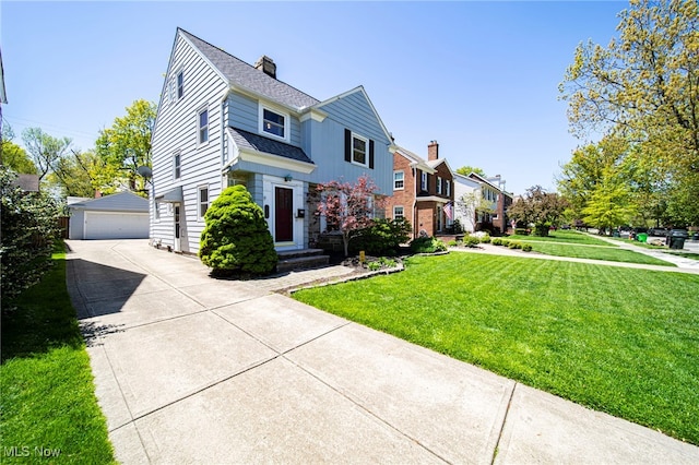 traditional home with a garage, a front yard, an outbuilding, a chimney, and a residential view