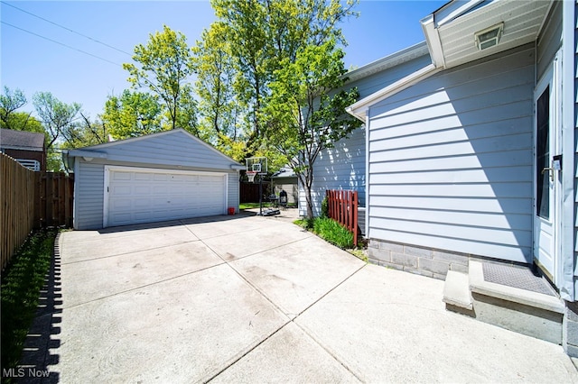 detached garage featuring fence