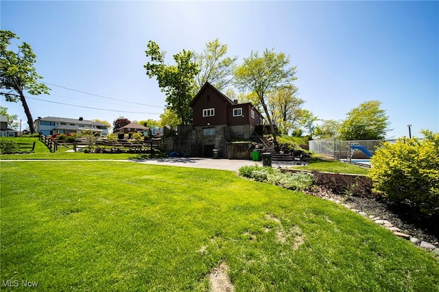 view of yard featuring stairway and a patio