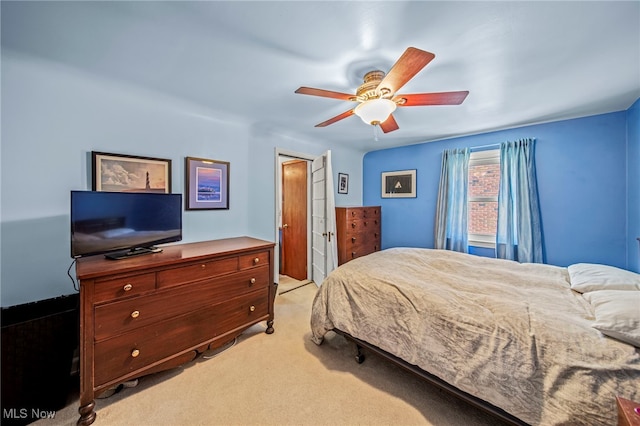 bedroom with light colored carpet and a ceiling fan