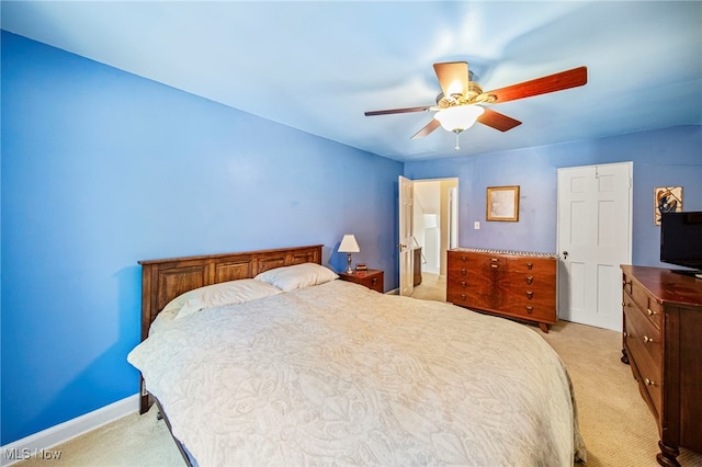 bedroom with light carpet, a ceiling fan, and baseboards