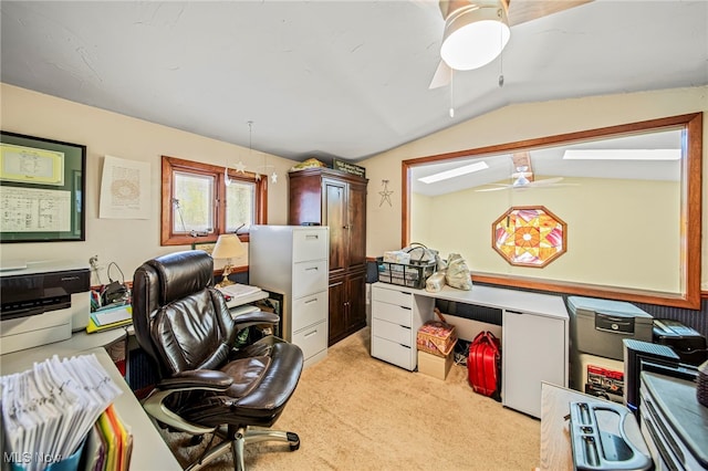 home office with a ceiling fan, vaulted ceiling, and light carpet