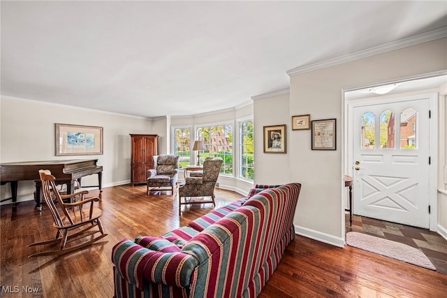 living area featuring baseboards, wood finished floors, and ornamental molding