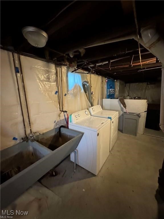 unfinished below grade area featuring washer and dryer