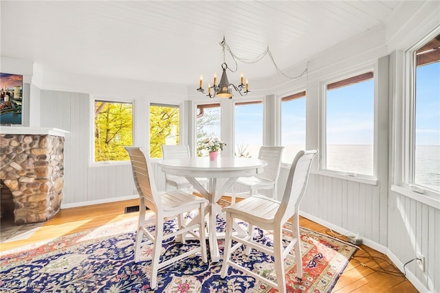 dining space with light wood-style floors, a chandelier, and plenty of natural light