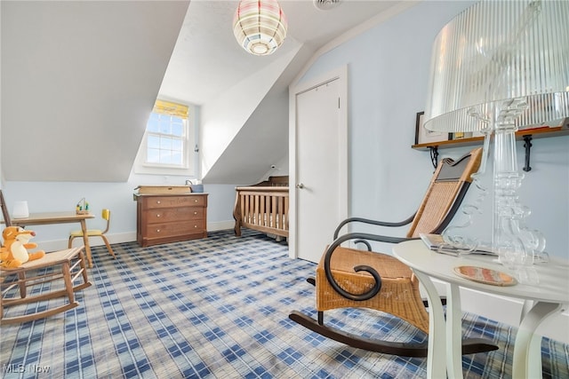 carpeted bedroom with lofted ceiling and baseboards