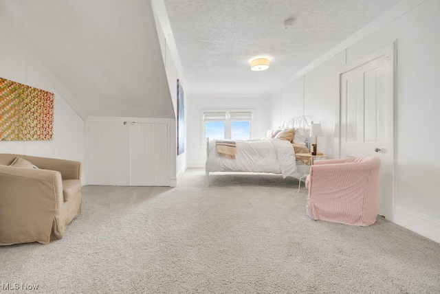 carpeted bedroom with a textured ceiling