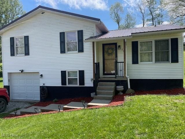 206 Anderson Ave, Bethesda, OH 43719 - split level home featuring metal roof, a front yard, and a garage