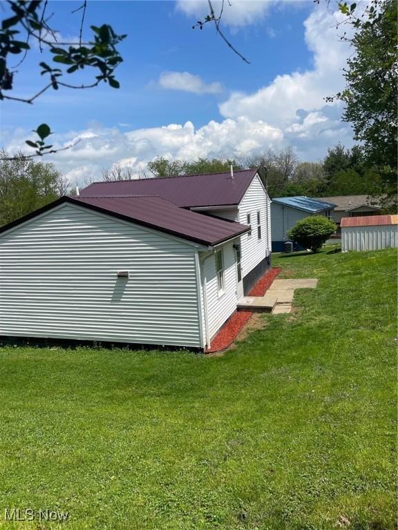 206 Anderson Ave, Bethesda, OH 43719 - view of property exterior with a yard and metal roof