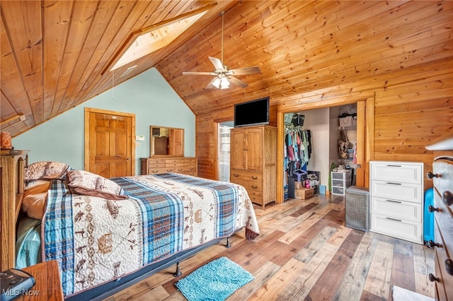 bedroom with vaulted ceiling, hardwood / wood-style flooring, wood ceiling, a closet, and wooden walls