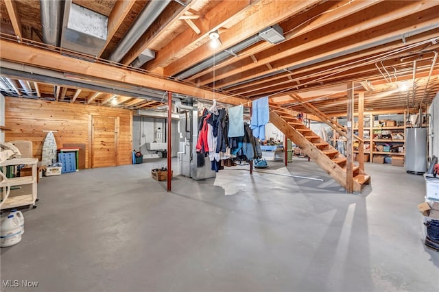 15180 Stoltz Rd, Diamond, OH 44412 - unfinished below grade area with water heater, stairs, wooden walls, and heating unit