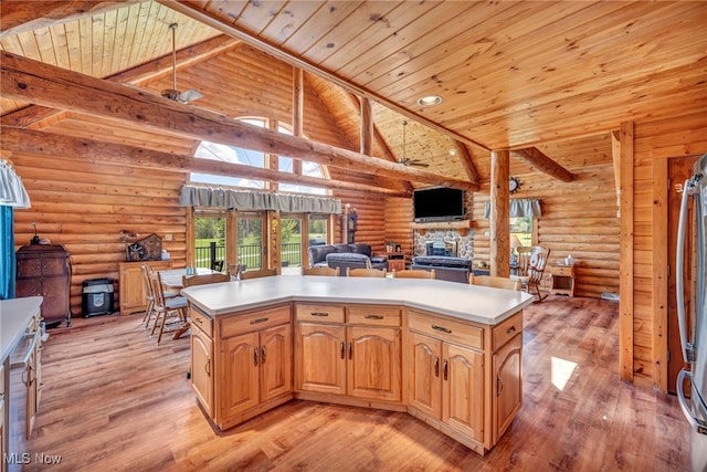 kitchen featuring open floor plan, a stone fireplace, rustic walls, wood ceiling, and light wood-style flooring