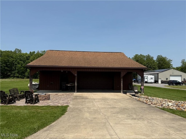 15180 Stoltz Rd, Diamond, OH 44412 - view of front facade featuring an outdoor fire pit, a front lawn, a shingled roof, and an outdoor structure