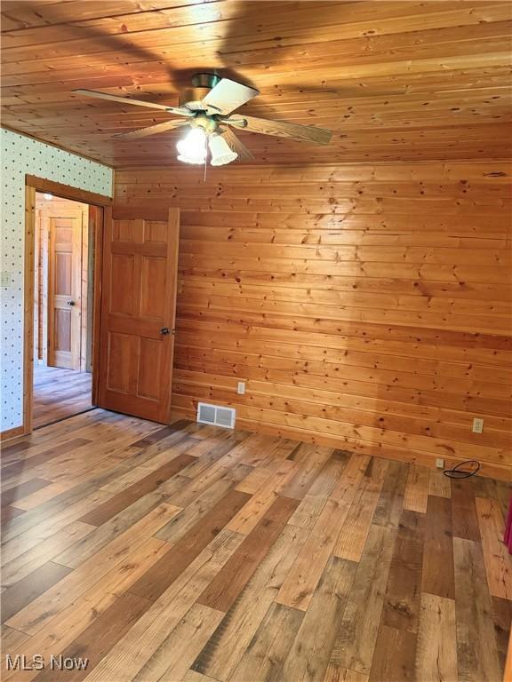 15180 Stoltz Rd, Diamond, OH 44412 - unfurnished room with a ceiling fan, light wood-type flooring, wallpapered walls, and wood ceiling