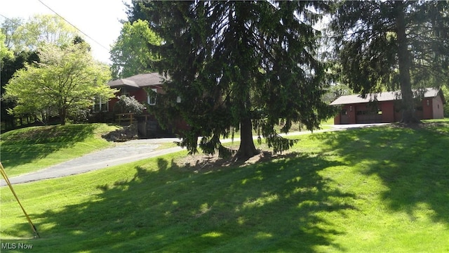 7517 Veterans Blvd, Chester, WV 26034 - view of grassy yard featuring a garage and driveway