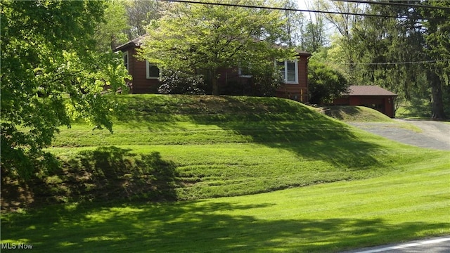 7517 Veterans Blvd, Chester, WV 26034 - view of front of house featuring a front lawn and asphalt driveway