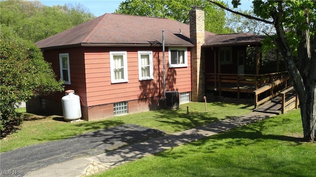 7517 Veterans Blvd, Chester, WV 26034 - rear view of house featuring a chimney, a lawn, and roof with shingles