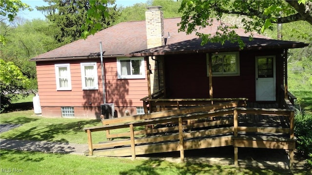 7517 Veterans Blvd, Chester, WV 26034 - back of property with a wooden deck, a chimney, a lawn, and a shingled roof