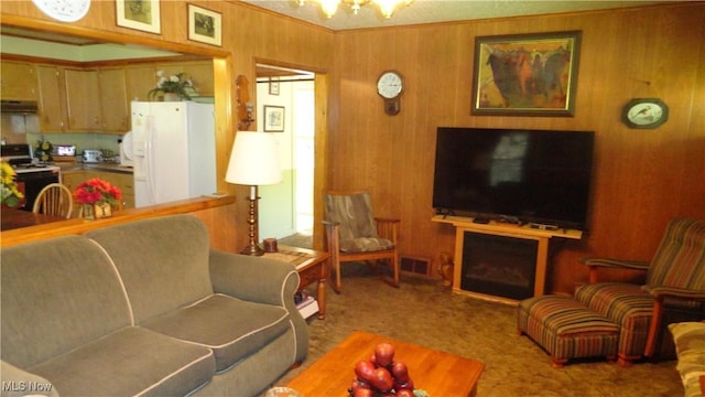 7517 Veterans Blvd, Chester, WV 26034 - carpeted living room with wood walls