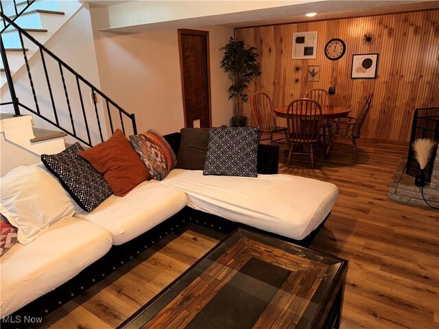 2201 Jackson St, Lorain, OH 44052 - living area with wood finished floors, wood walls, and stairway
