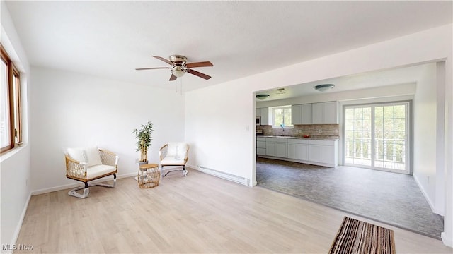 32 Ash Cir, Davisville, WV 26142 - unfurnished room featuring a sink, ceiling fan, light wood-type flooring, and baseboards