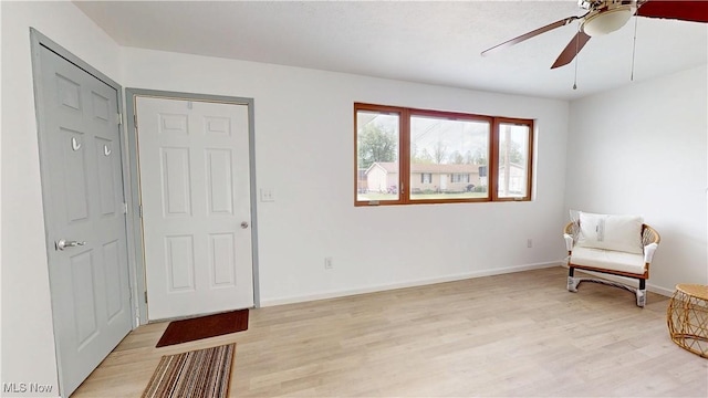 32 Ash Cir, Davisville, WV 26142 - living area featuring light wood-type flooring, ceiling fan, and baseboards