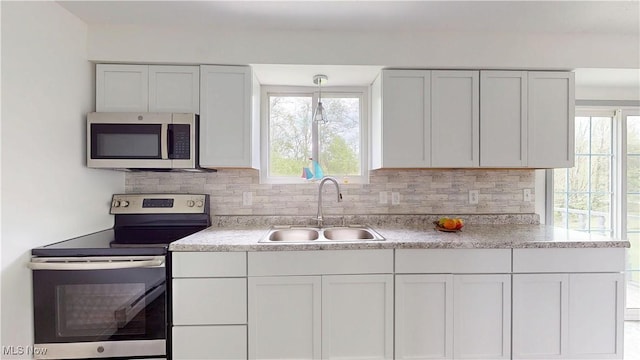 32 Ash Cir, Davisville, WV 26142 - kitchen featuring stainless steel appliances, a sink, decorative backsplash, white cabinets, and plenty of natural light