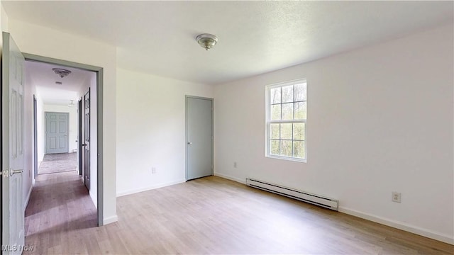 32 Ash Cir, Davisville, WV 26142 - unfurnished bedroom featuring a baseboard radiator, light wood finished floors, and baseboards